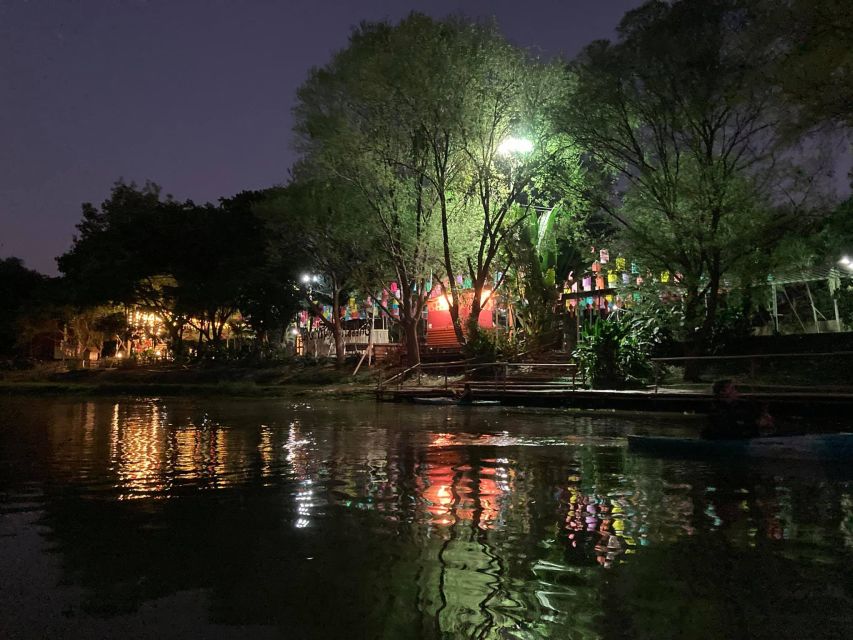 Chiang Mai: Ping River Night Kayaking into City Center - Bridges, restaurants, and the night skyline from water level